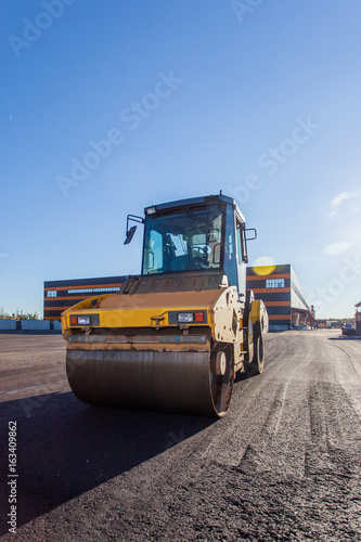 Work on asphalt paving on a sunny day	 