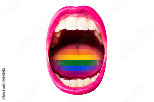 Flag of LGBT in woman's mouth, on tongue, sexy concept of rainbow flag. Female lips with lipstick, white teeth, rainbow in tongue of girl. Woman screams at rally pride about rights of minorities