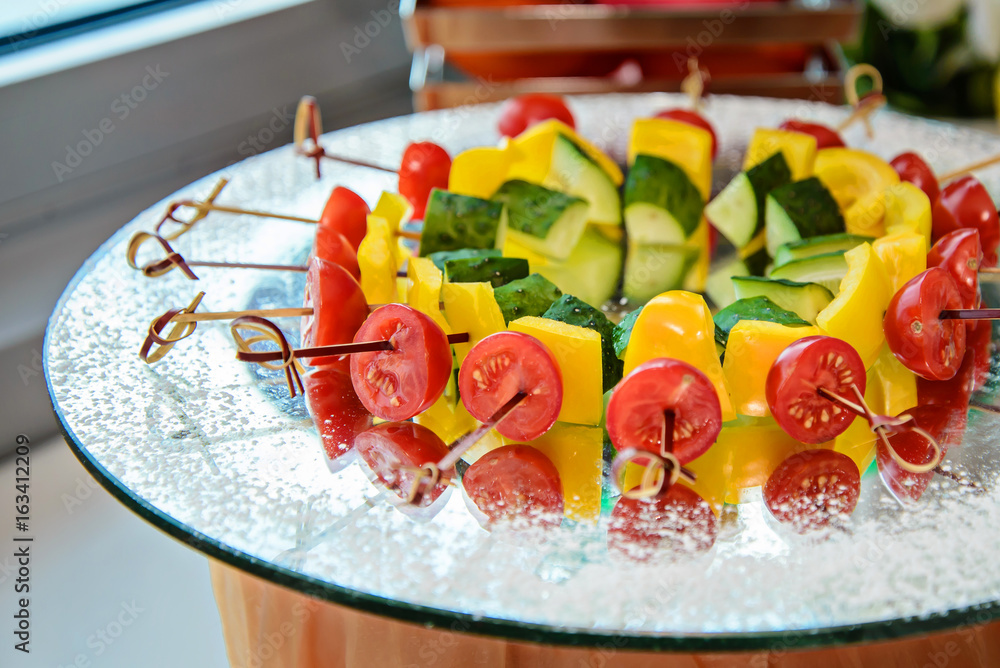 Colorful vegetables on the skewers in the dish