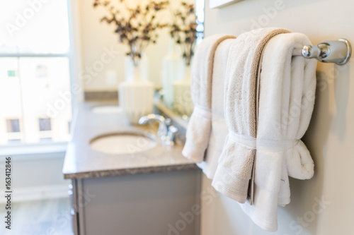 Modern bathroom with two sinks and towels hanging on rack