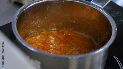 Tpumpkin boiling in a pot on the stove. Pumpkin syrup is boiling in a saucepan. Thai delicious dessert photo