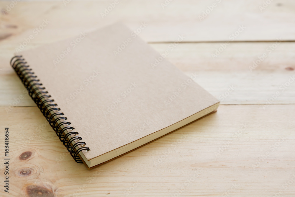 Fototapeta premium Book cover on textured wood background.