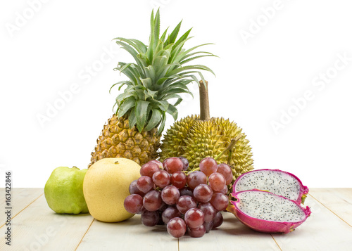 Set of different fruits on wooden table on white background.