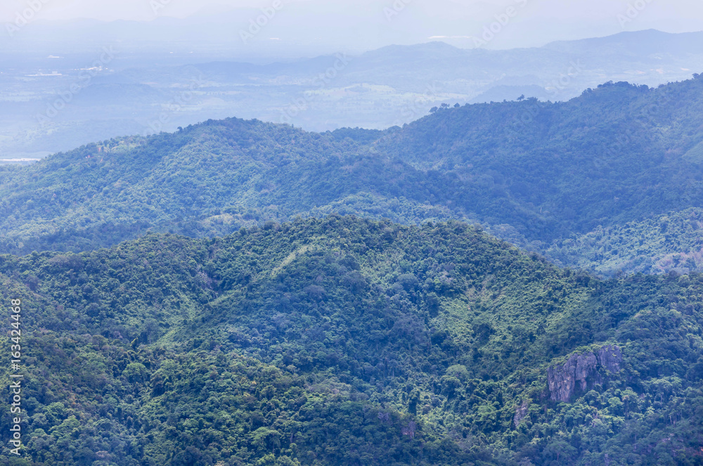    high angle viewpoint over rainforest mountains Thailand.