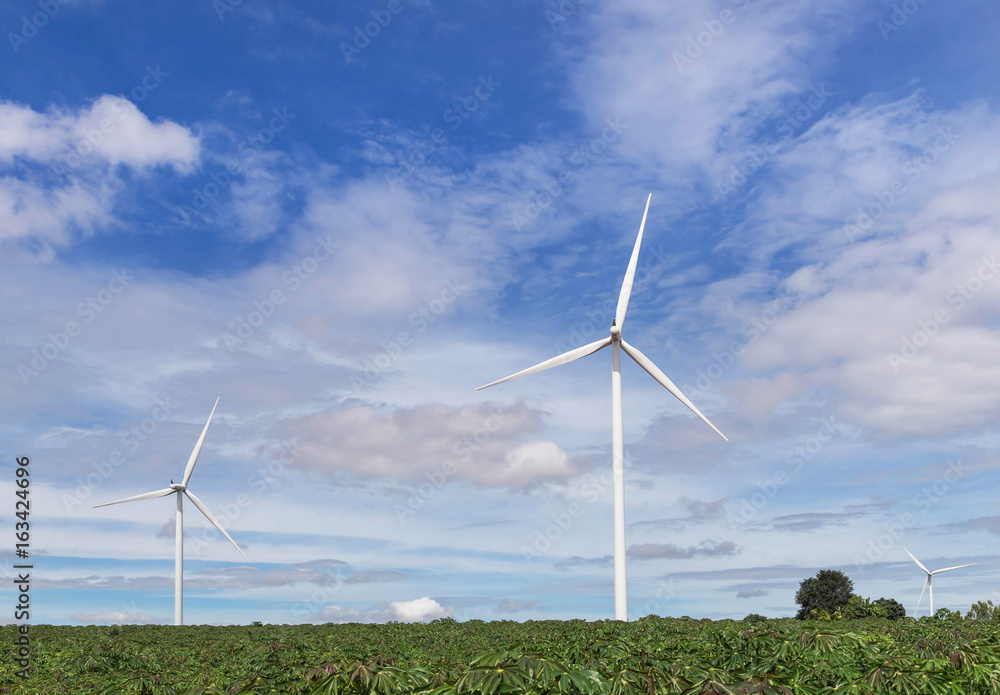 white wind turbines generating electricity in wind power station under blue sky background white wind turbines generating electricity in wind power station under blue sky background