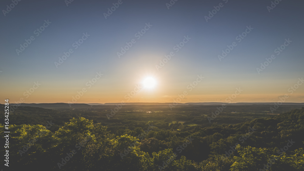 The sun setting over the countryside, panoramic landscape.