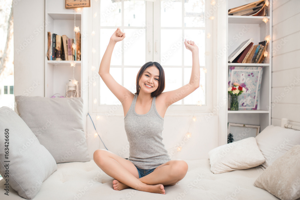Beautiful young woman relaxing on the bed in the morning Beautiful young woman relaxing on the bed in the morning