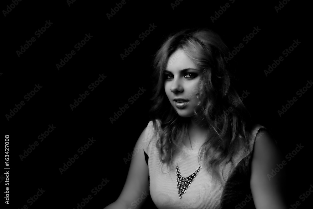 Black and white low key portrait of attractive long hair young woman. Black and white low key portrait of attractive long hair young woman.