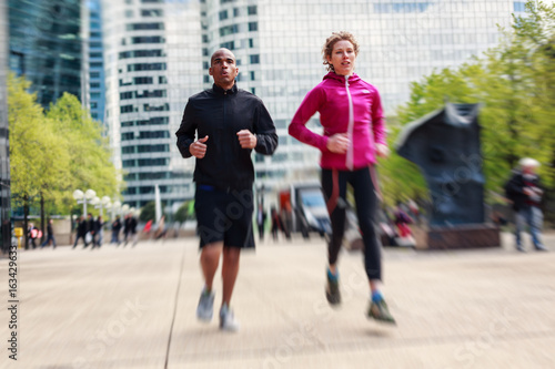 Multi-ethnic Couple Jogging In Urban Setting