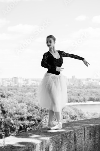 Young beautiful ballerina in city at sunny day, dancing and give a positive and inspiration for other people