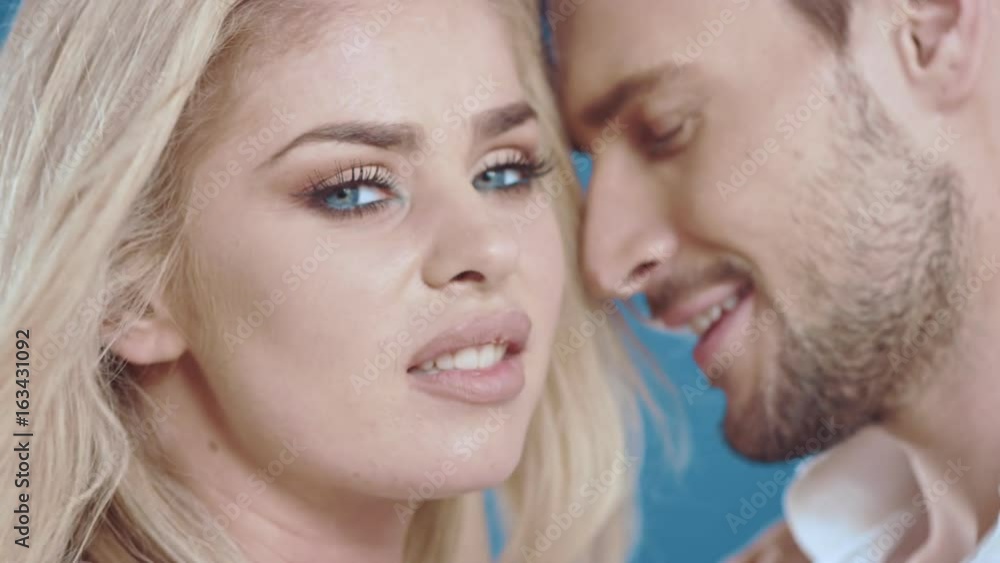 Sexy young couple posing on studio background, 4k slow motion studio clip Sexy young couple posing on studio background, 4k slow motion studio clip