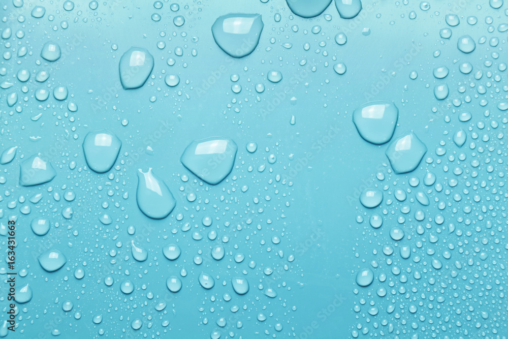 Water drops on a smooth surface, blue background