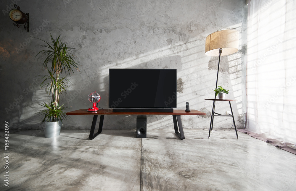 Modern living-room interior with TV in a loft style with wooden TV deck and  concrete