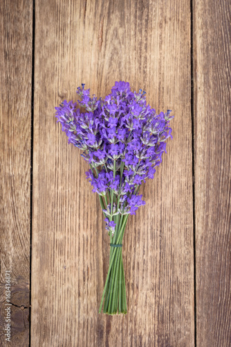 Bouquet of lavender on rustic brown wooden background 
