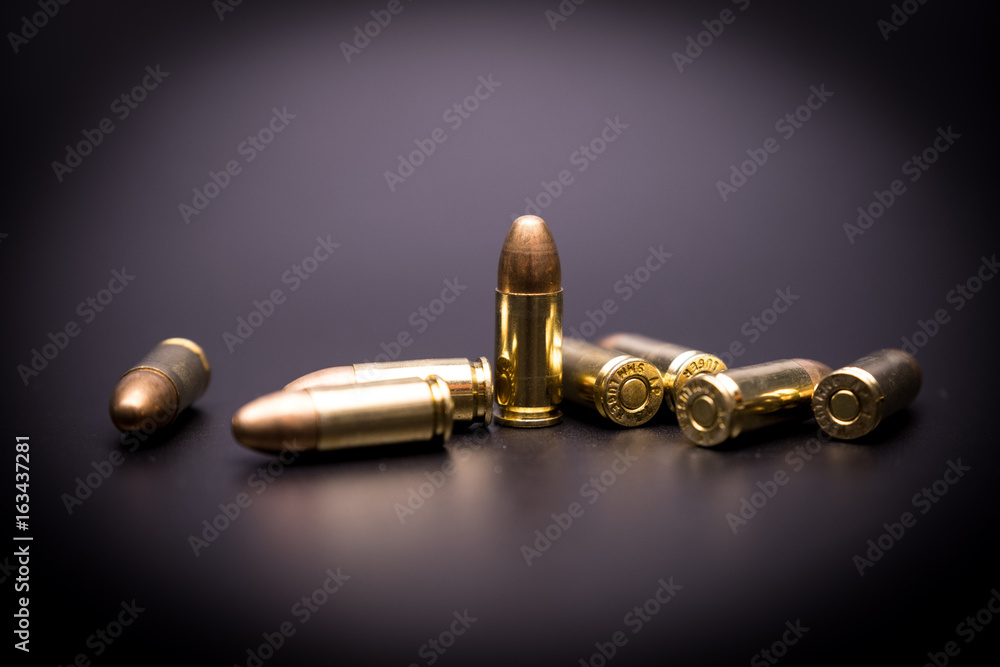 9 mm full metal jacket bullet on black background 9 mm full metal jacket bullet on black background