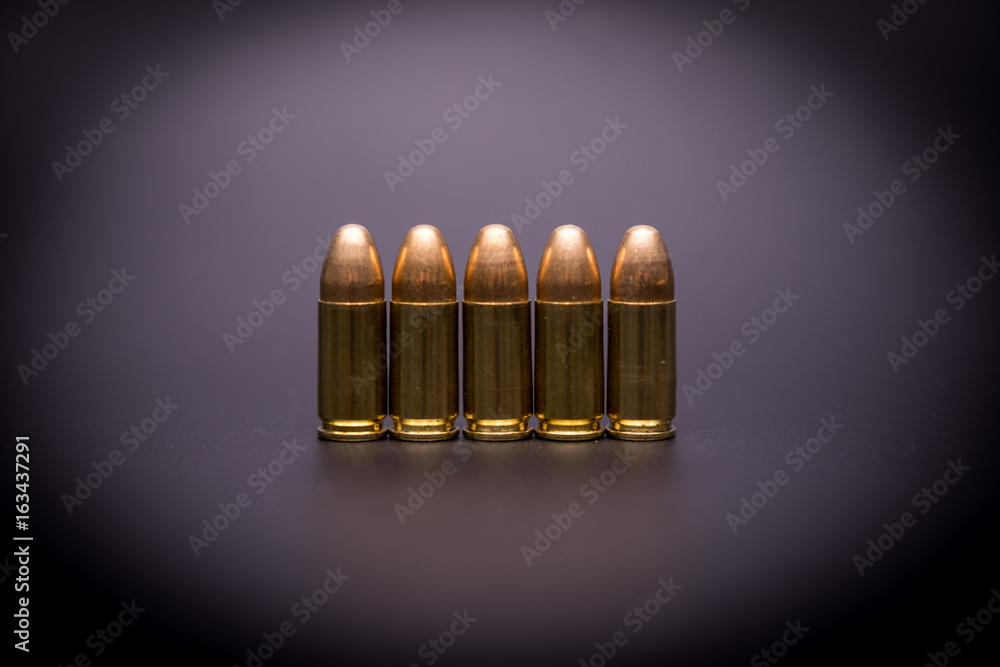 9 mm full metal jacket bullet on black background 9 mm full metal jacket bullet on black background
