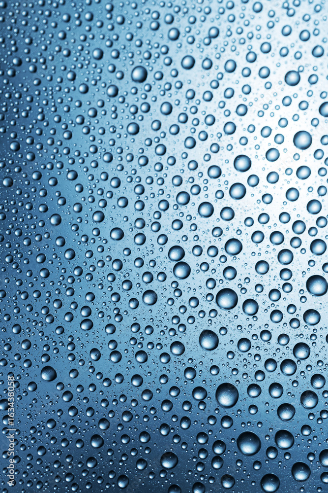 Water drops on surface, abstract blue background
