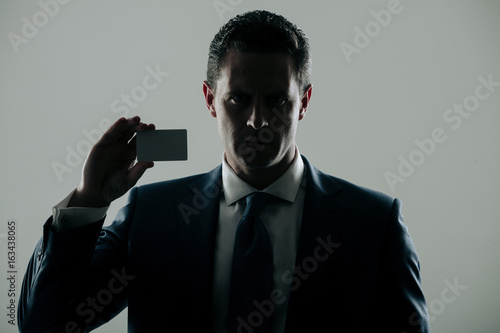 Принти на полотні shadow business, businessman holding bank or business card