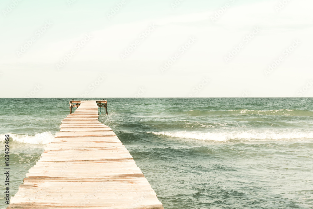 Retro photo of a pier in wood from the beach