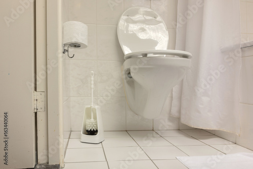 Toilet brush in a simple bathroom