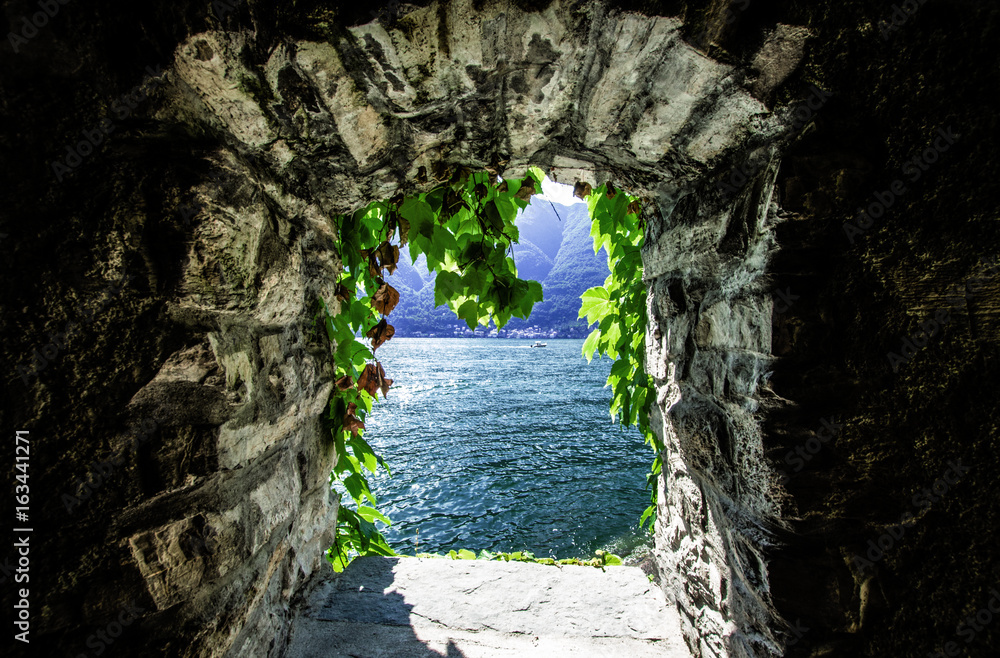 Old window overlooking the beautiful como lake Old window overlooking the beautiful como lake