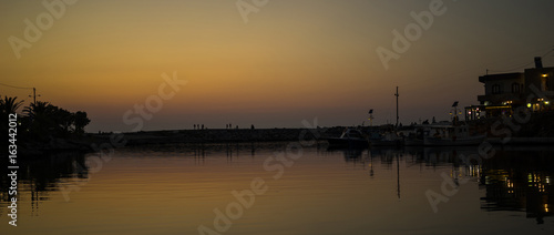 Romantic sunset in a harbor of Crete