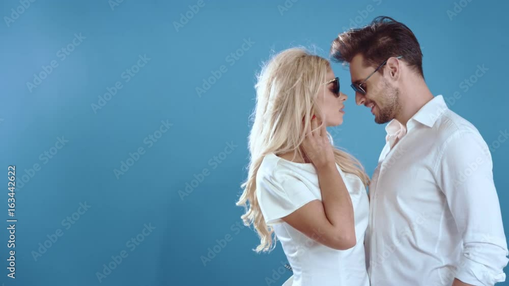 Sexy young couple posing on studio background, 4k slow motion studio clip Sexy young couple posing on studio background, 4k slow motion studio clip
