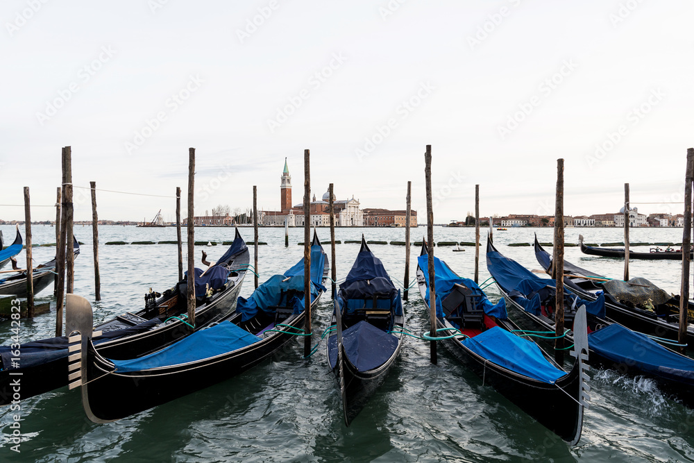 Row of gondolas in Venice laguna, Italy