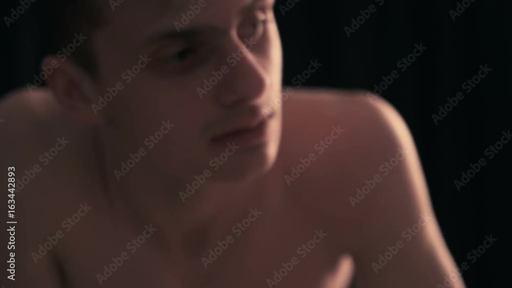 Young guy looks into camera and says something close up Young guy looks into camera and says something close up