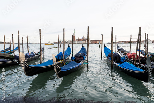Row of gondolas in Venice laguna, Italy © Bisual Photo