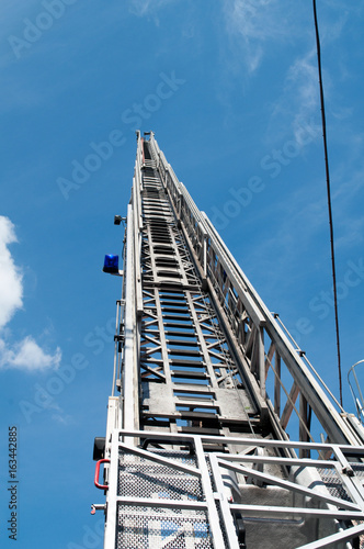 A tall fire escape ladder to the sky