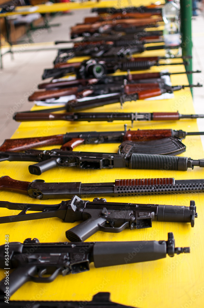 Guns on yellow table Guns on yellow table