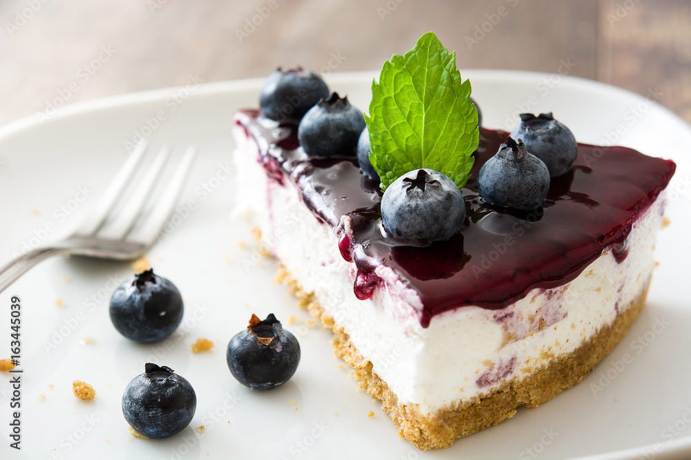 Piece of blueberry cheesecake on wooden table
Piece of blueberry cheesecake on wooden table
