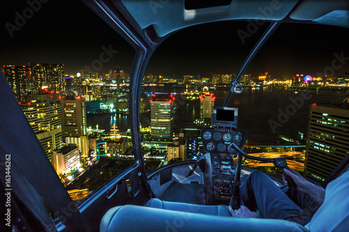 Photography Helicopter flying over Tokyo cityscape, the Bay area with its bridges and Odaiba by night from Tokyo skyline in Japan