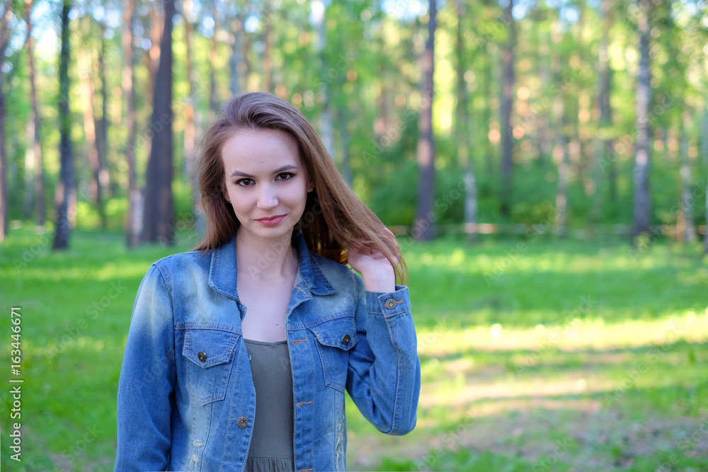 Woman smiling with perfect smile in a park and looking at camera Woman smiling with perfect smile in a park and looking at camera