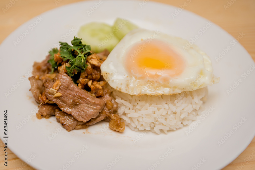 Pork fried garlic with rice and fried egg, Thai food Pork fried garlic with rice and fried egg, Thai food