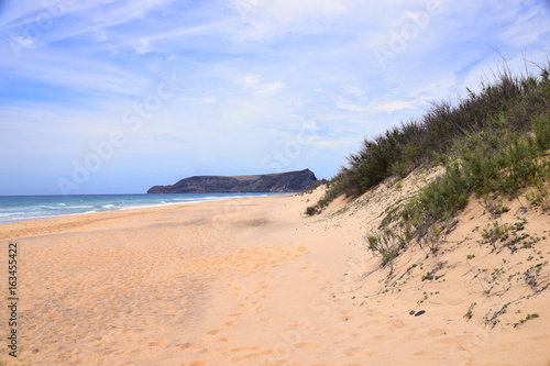 Deserted golden beach of Porto Santo looking towards beach of Porto Santo looking towards the uninhabited Ilhéu da Cal, Porto Santo, Madeira, Portugal