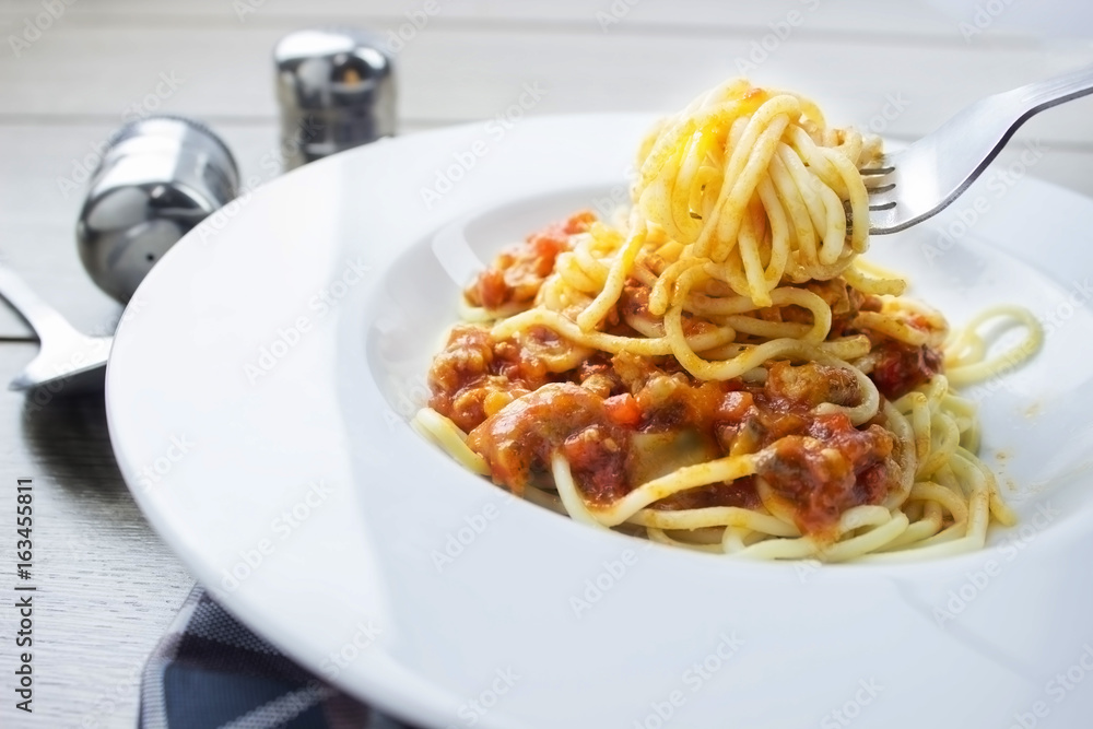 Spaghetti bolognese pasta with tomato sauce,Fork holding spaghetti