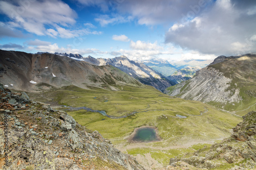 High peaks frame the alpine lakes and meadows, Filon Del Mott, Bormio, Braulio Valley, Stelvio Pass, Valtellina, Lombardy photo