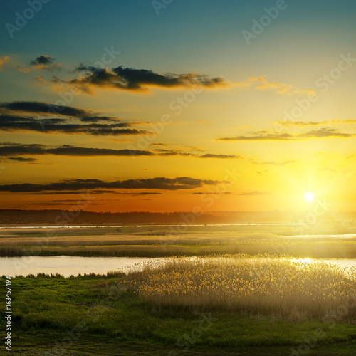 orange sunset and river in canes