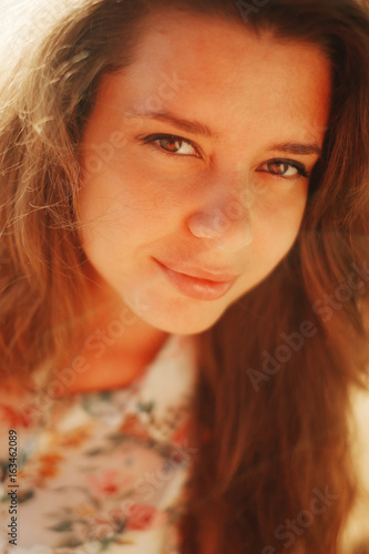 Close-up portrait of a young woman in the sun