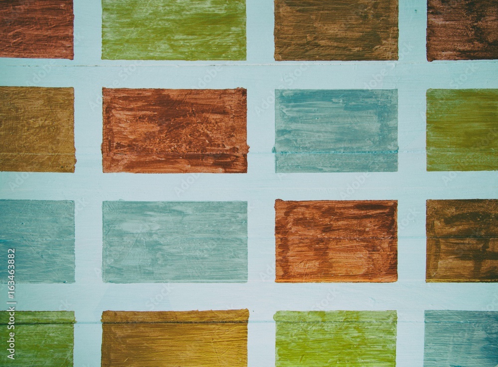 Green, bronze and silver squares on white wood panel background