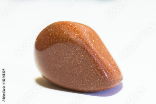 Precious stones - sunstone mineral shaped and polished- close up macro (on white)_