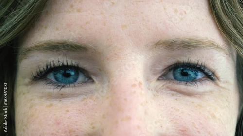 Close up of blue eyes young woman's face