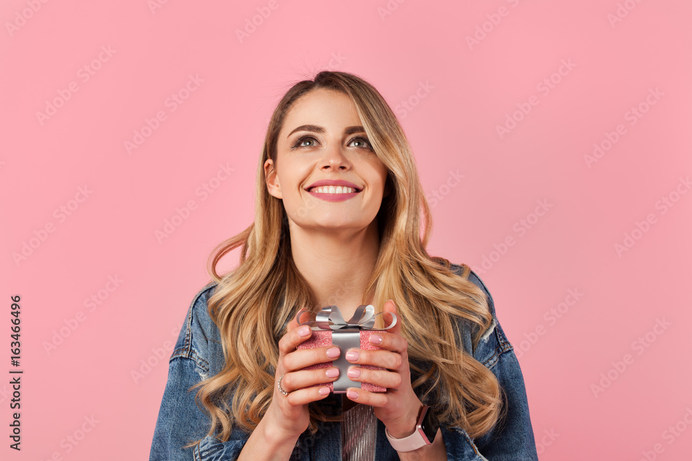 Content woman holding small giftbox Content woman holding small giftbox
