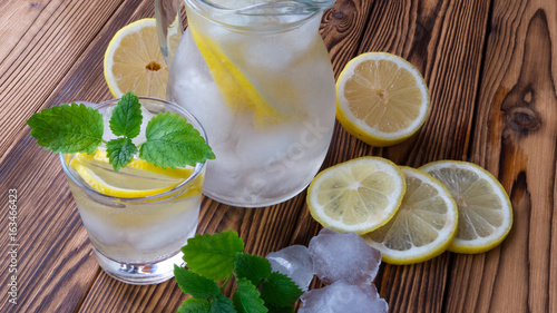 lemonade with ice and mint in a jug © olgapavlova