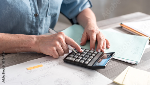 Female accountant using calculator photo