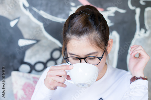 Portrait of asian women take a coffee break in cafeteria.
