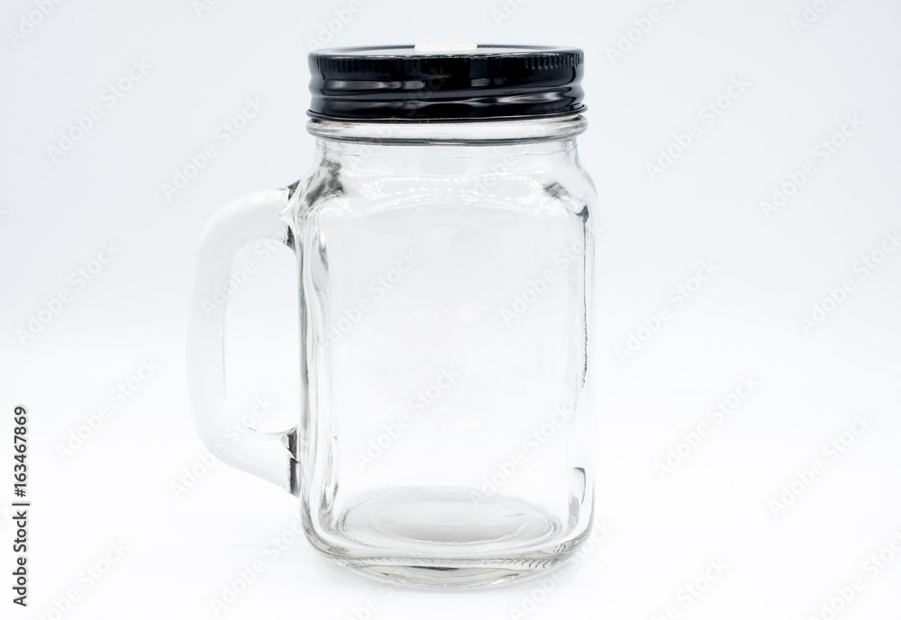 Glass bottle with black cap on isolated white background. Glass bottle with black cap on isolated white background.