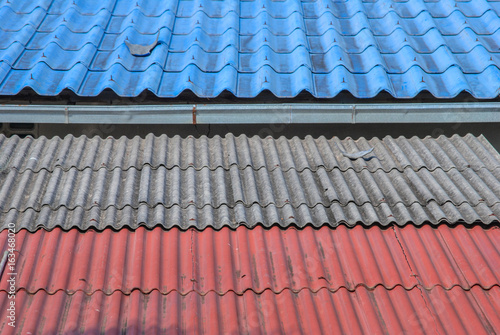 Deal of coloured corrugated iron on a roof, Thailand